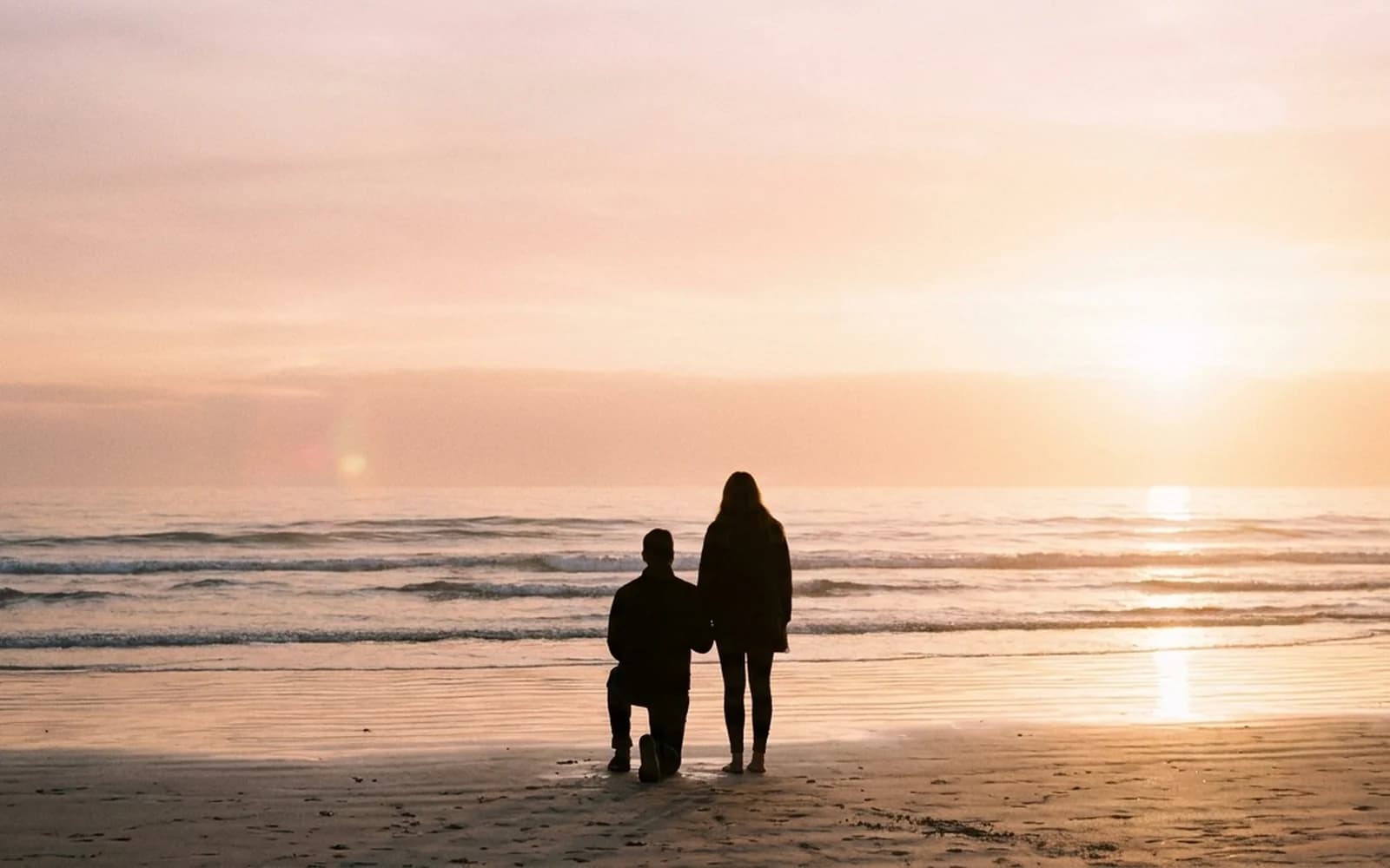 A sunset beach proposal silhouette on a Sydney beach